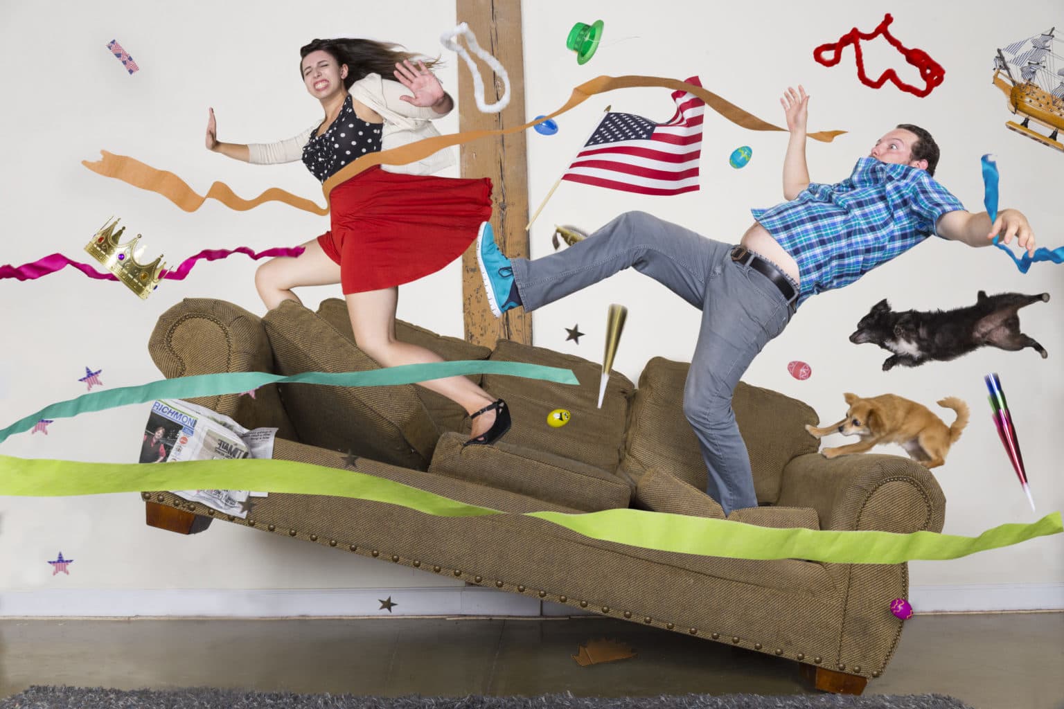 Lauren and Deven bracing against a gust of wind around the couch.