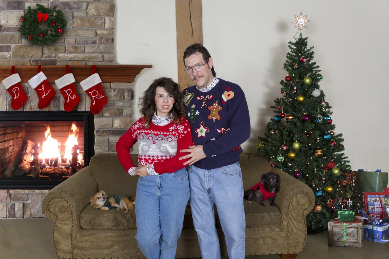 Lauren and Deven posing for an intentionally retro family portrait on the couch.