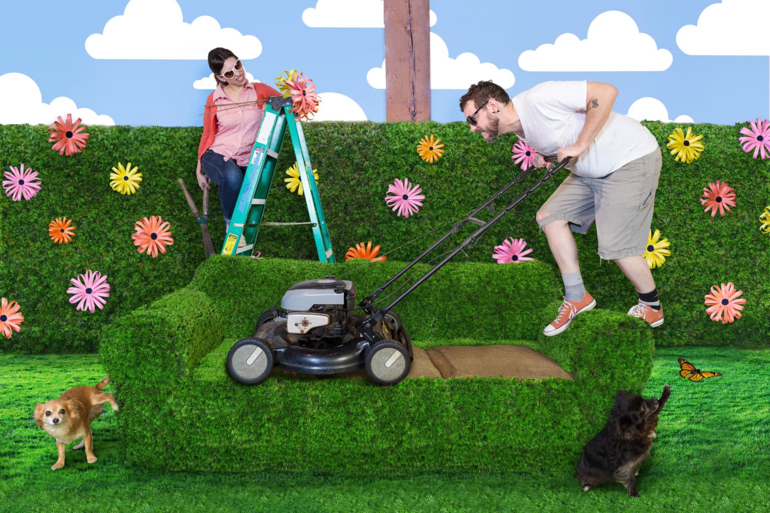 Lauren and Deven with a grass-covered couch and lawnmower.