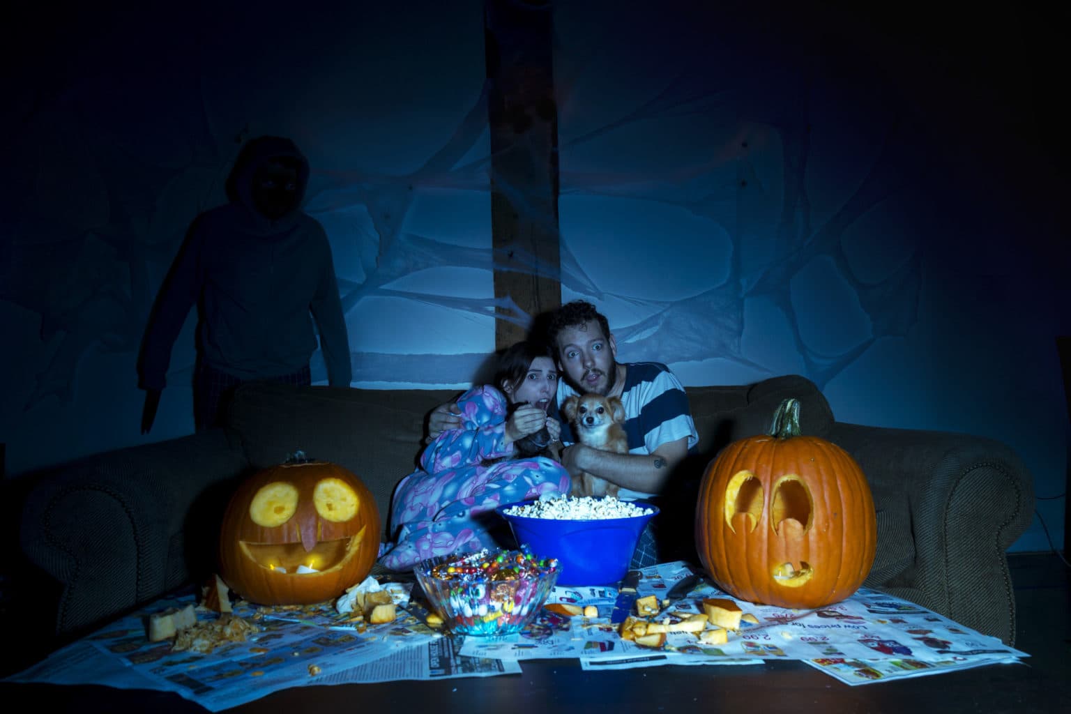 Lauren and Deven in a scary-movie scene on the couch.