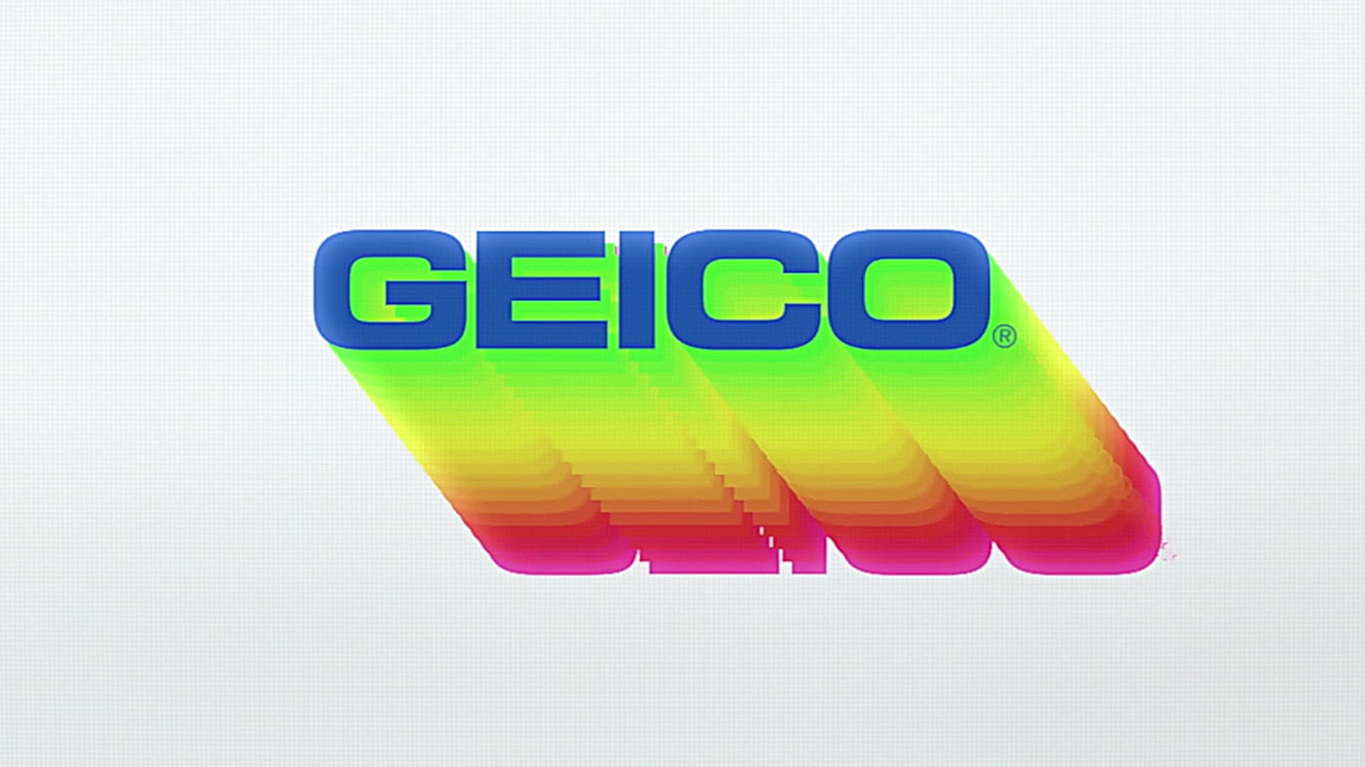 Colorful three-dimensional GEICO lettering floating above a pale surface.